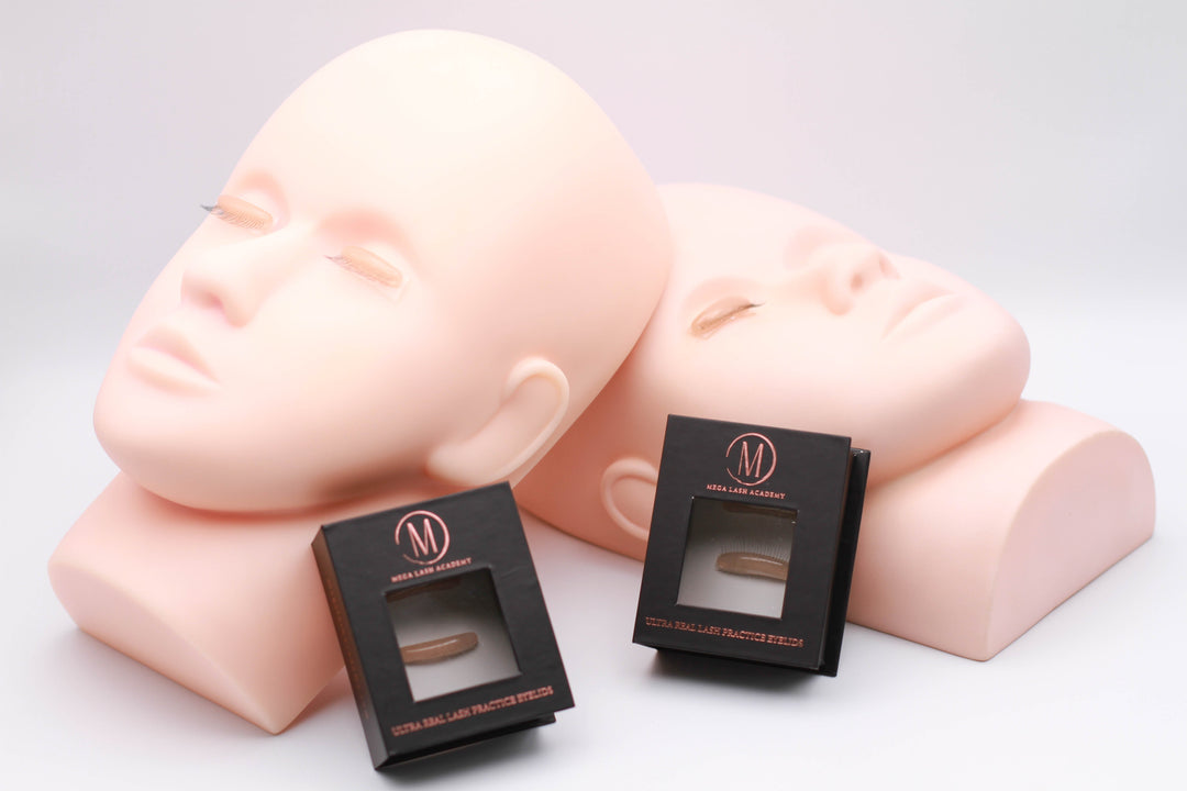 Two mannequin heads with Ultra Real Lash Practice Eyelids used as realistic lash training tool